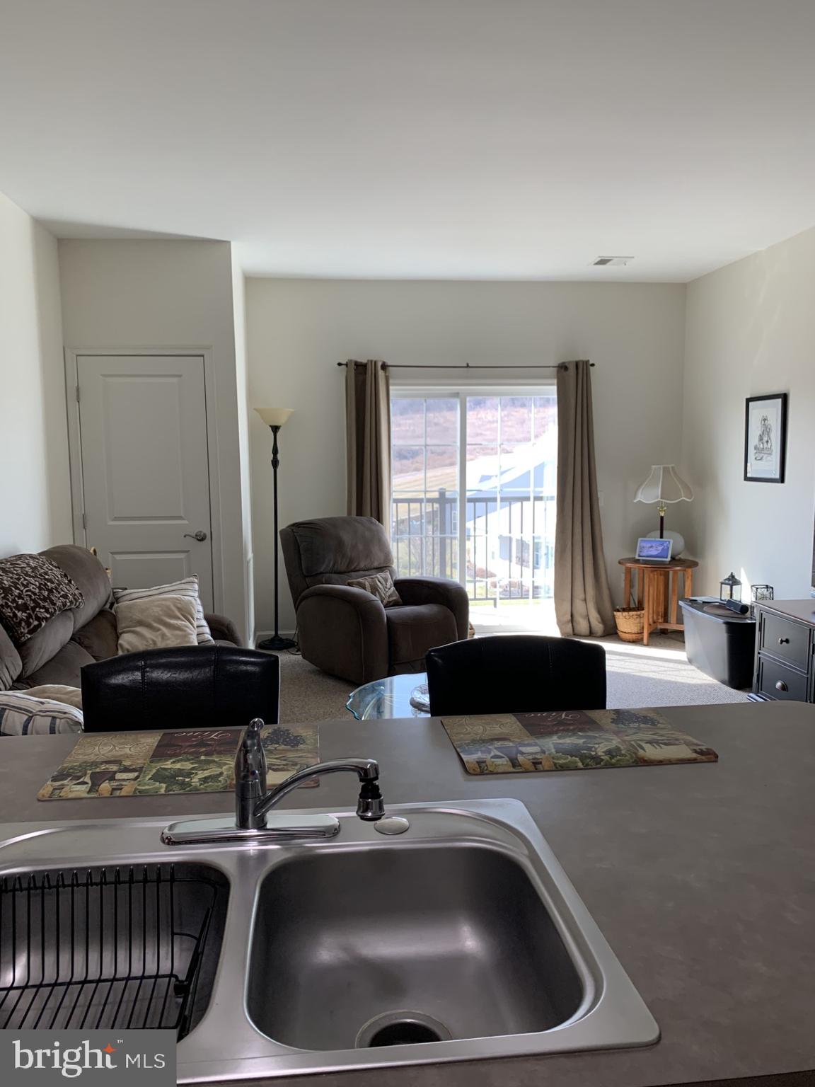 79 Legacy Boulevard, Unit 102 Sinking Spring, PA 19608 - Photo 6 of 11 a kitchen with a sink and a stove top oven