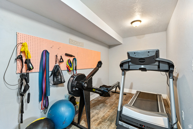 580 Cherry Ridge Lane Richmond, UT 84333 - Photo 39 of 53 Exercise room featuring wood finished floors and a textured ceiling