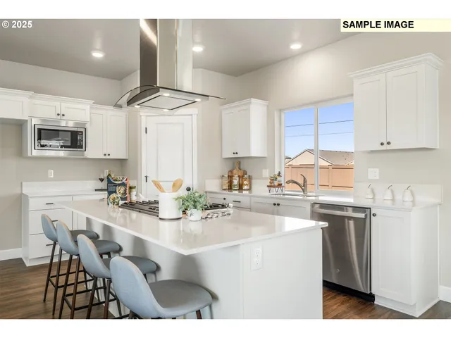 a kitchen with a stove a sink and a refrigerator
