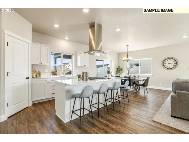 a kitchen with white cabinets and sink