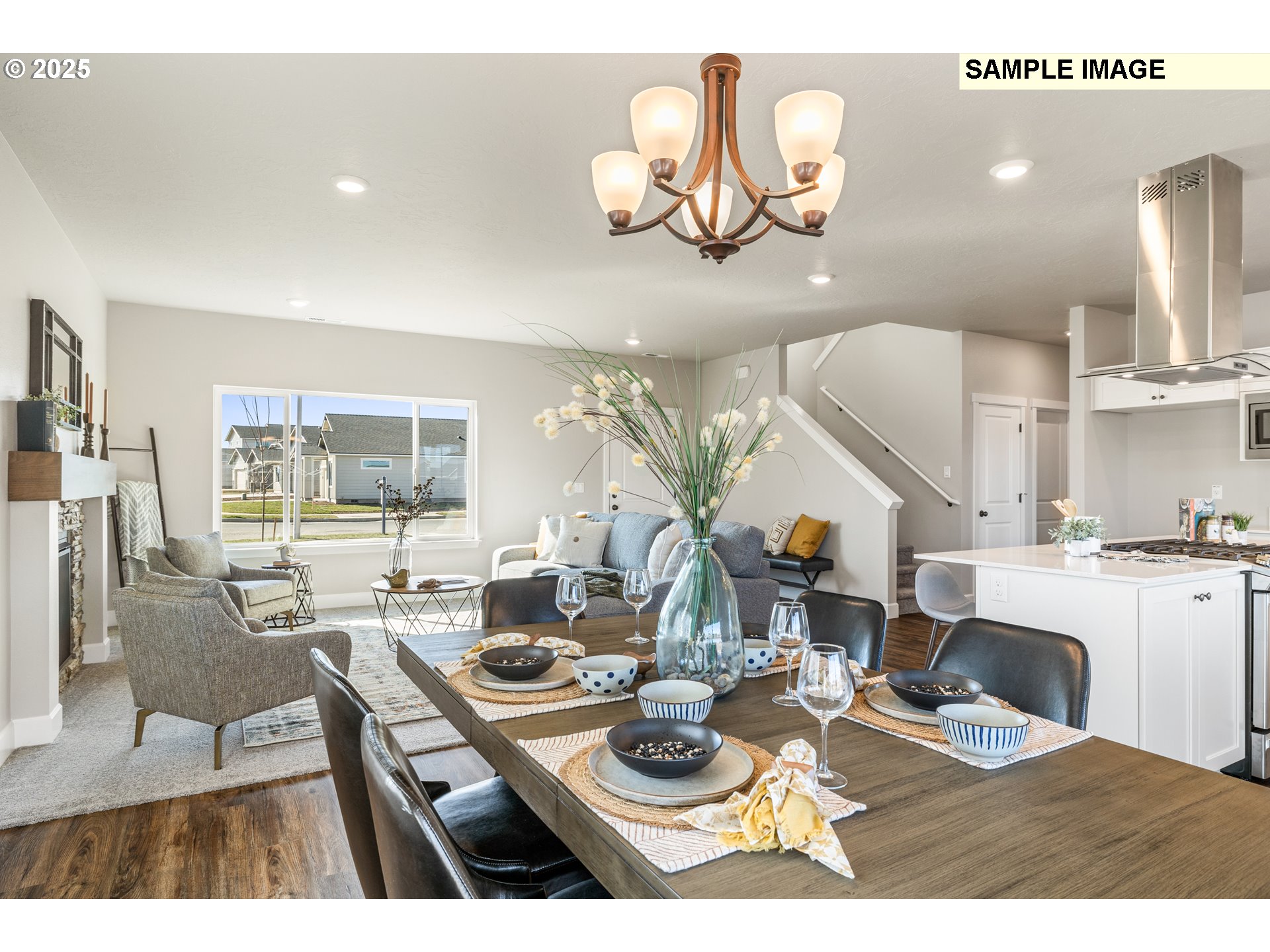 548 Arthur Street Umatilla, OR 97882 - Photo 17 of 36 a dining room with wooden floor a chandelier a wooden table and chairs