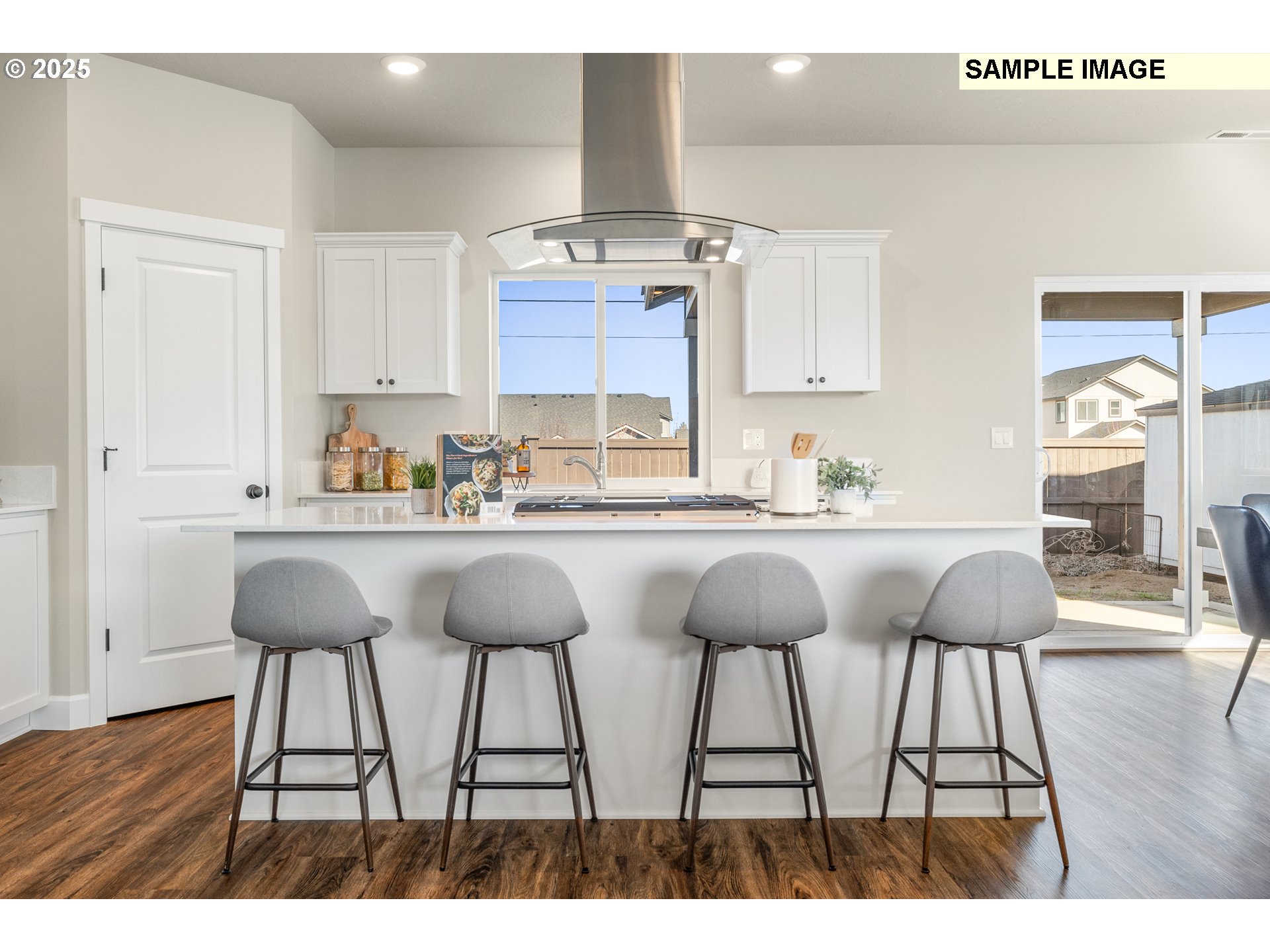 548 Arthur Street Umatilla, OR 97882 - Photo 10 of 36 a kitchen with a dining table chairs and white cabinets