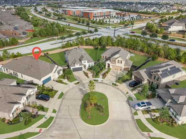 an aerial view of a house with swimming pool and outdoor seating