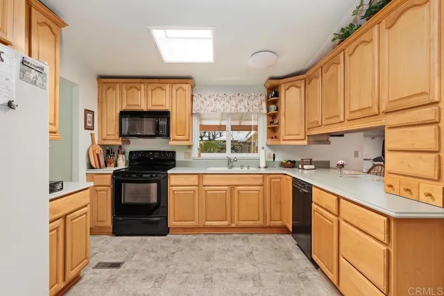 a kitchen with stainless steel appliances granite countertop a stove sink and cabinets
