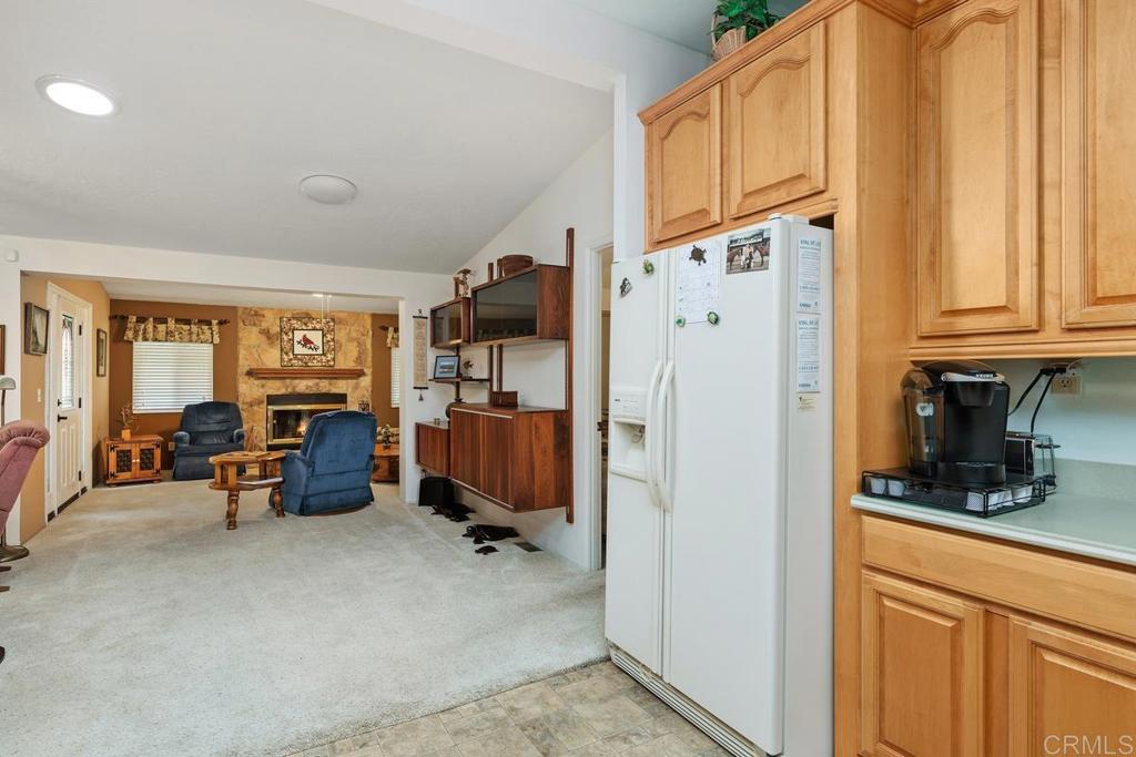 18218 Paradise Mountain Road Valley Center, CA 92082 - Photo 16 of 39 a kitchen with stainless steel appliances a refrigerator and cabinets