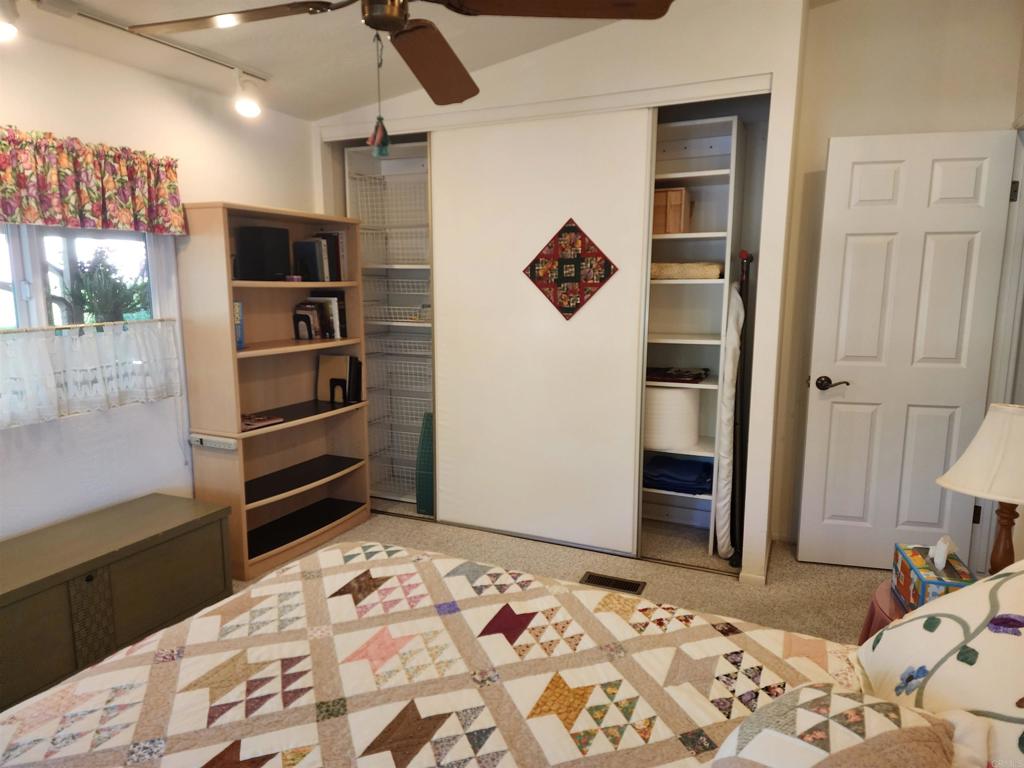 18218 Paradise Mountain Road Valley Center, CA 92082 - Photo 22 of 39 a bedroom with a bed and a dresser