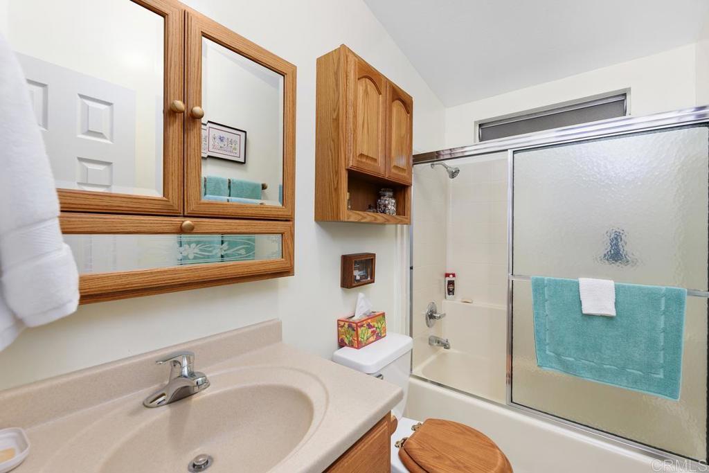 18218 Paradise Mountain Road Valley Center, CA 92082 - Photo 23 of 39 a bathroom with a sink and a shower