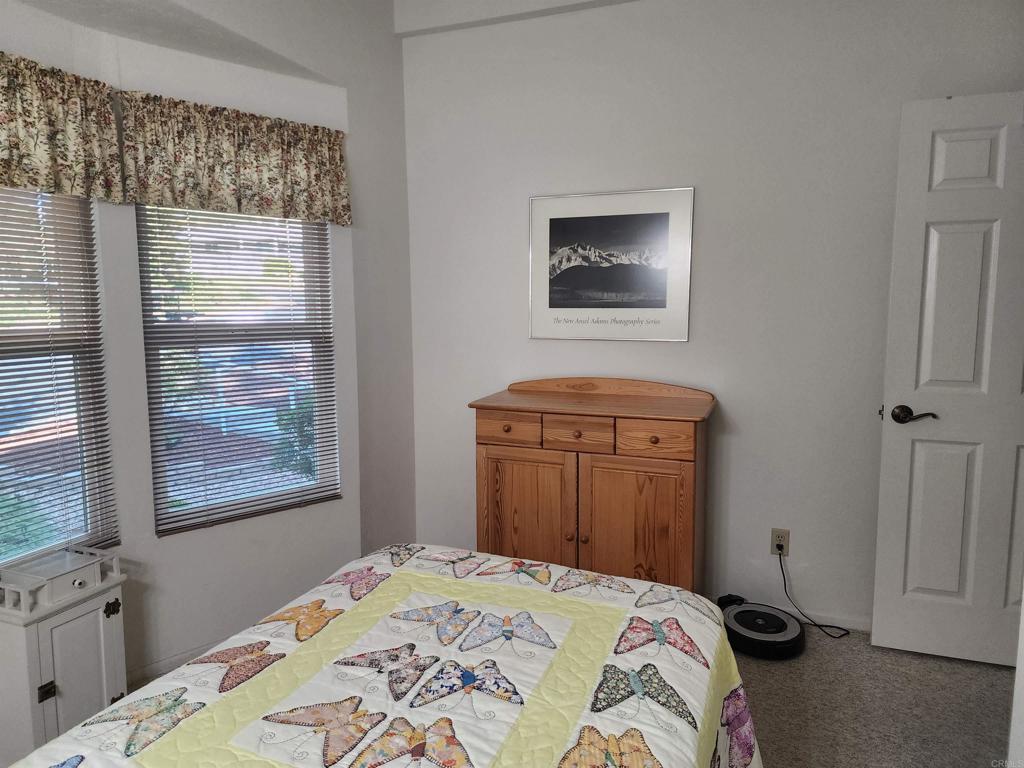 18218 Paradise Mountain Road Valley Center, CA 92082 - Photo 26 of 39 a bedroom with a bed and a window