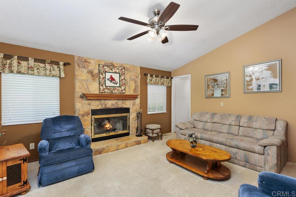 18218 Paradise Mountain Road Valley Center, CA 92082 - Photo 6 of 39 a living room with furniture and a fireplace
