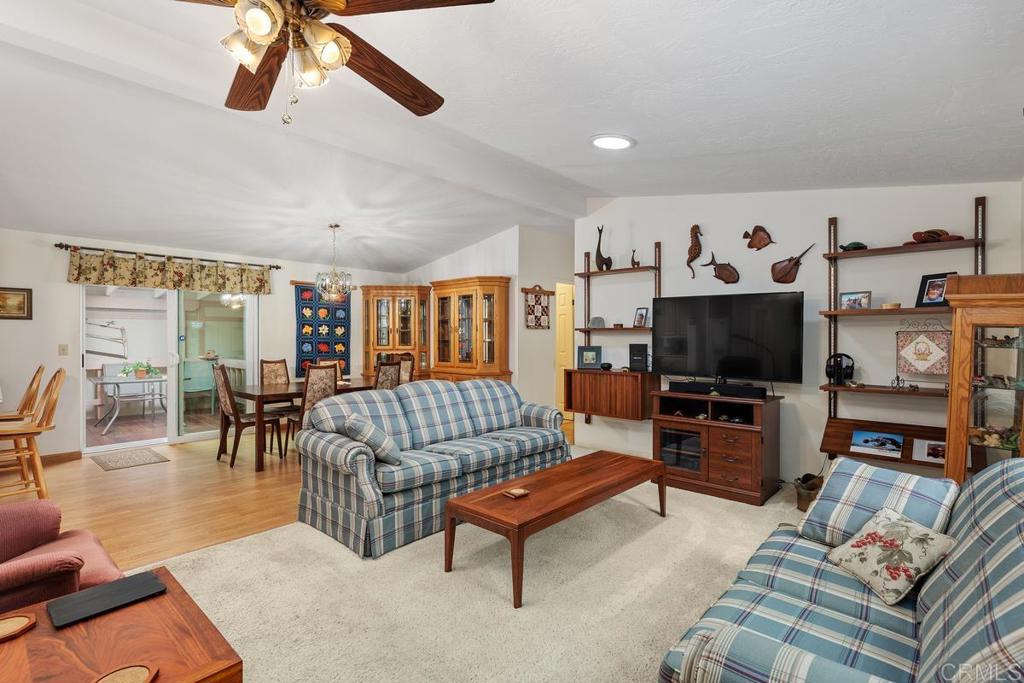 18218 Paradise Mountain Road Valley Center, CA 92082 - Photo 9 of 39 a living room with furniture and a flat screen tv