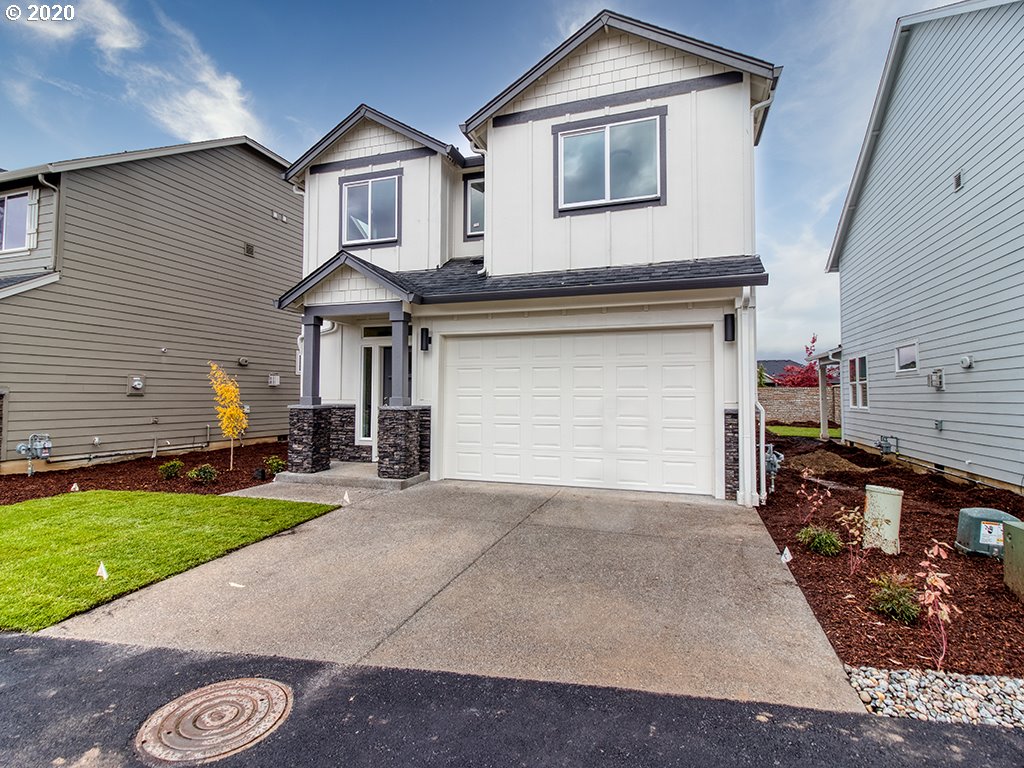 70 South 39th Drive Ridgefield, WA 98642 - Photo 1 of 24 a front view of a house with a yard and garage