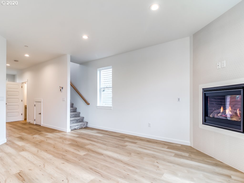 70 South 39th Drive Ridgefield, WA 98642 - Photo 7 of 24 a view of an empty room with wooden floor and a window