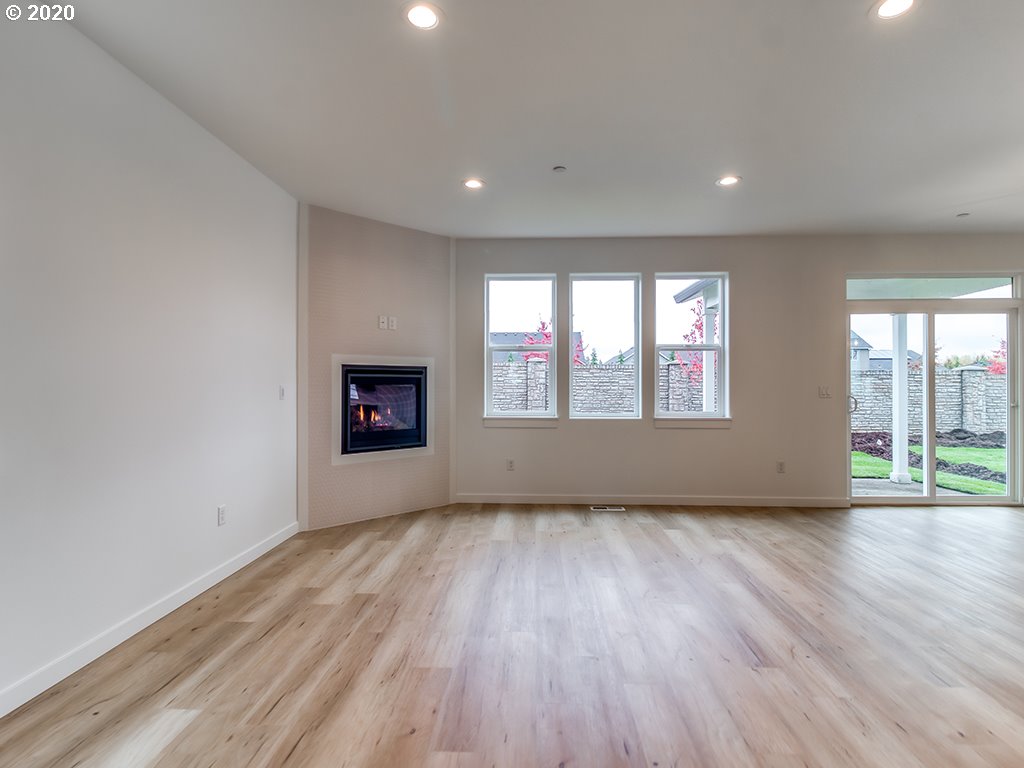 70 South 39th Drive Ridgefield, WA 98642 - Photo 9 of 24 an empty room with wooden floor and windows