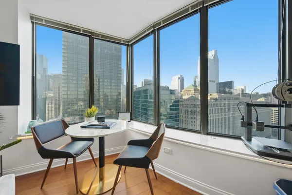 a dining room with furniture and a floor to ceiling window