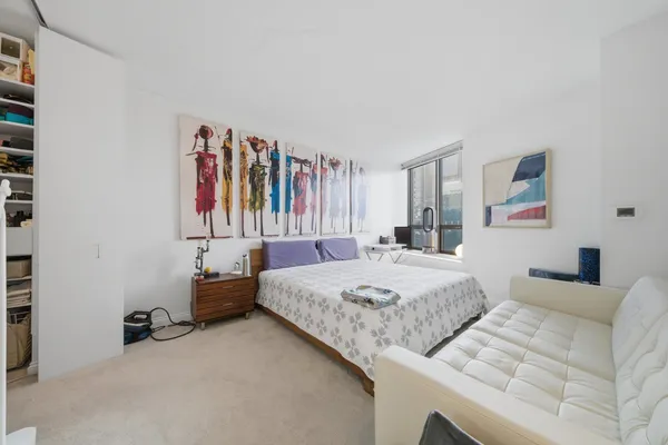 a bedroom with a bed and a cabinets