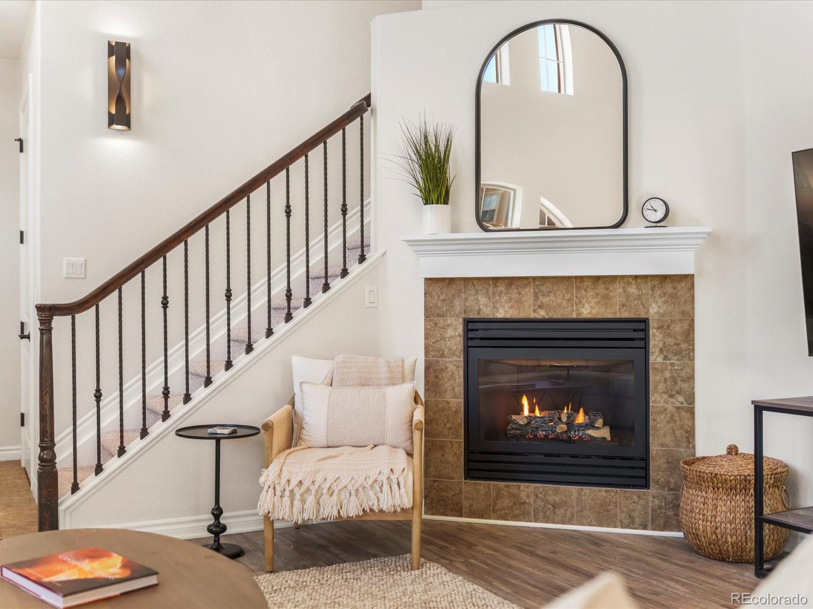 9340 Sori Lane Highlands Ranch, CO 80126 - Photo 7 of 42 a living room with furniture and a fireplace