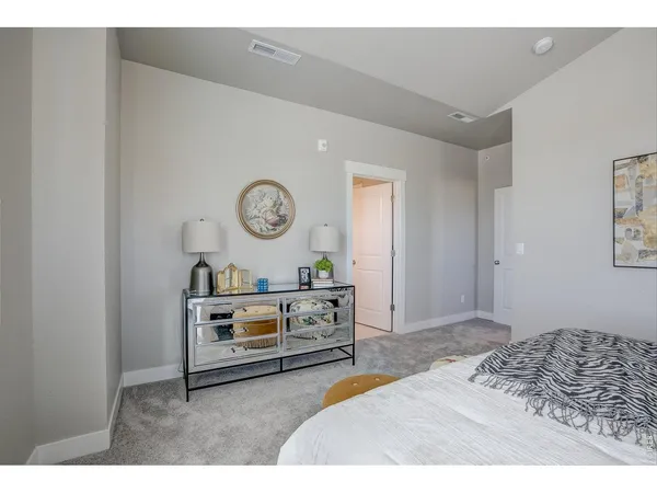 a bedroom with a bed and a potted plant