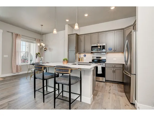 a kitchen with a sink a stove and cabinets