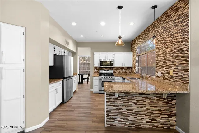 a kitchen view with microwave a stove and cabinets