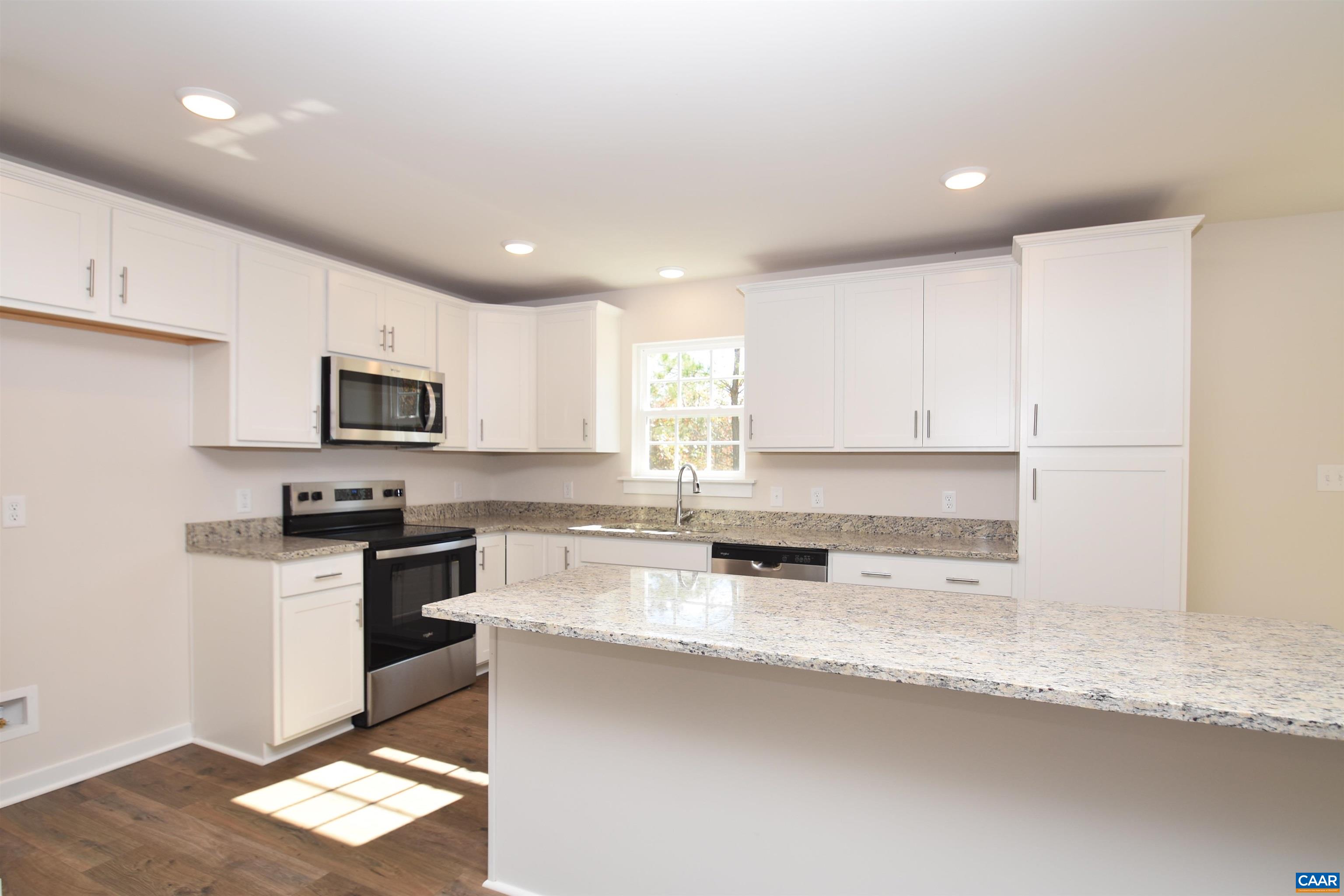 2600 Doctors Road Louisa, VA 23093 - Photo 5 of 25 a kitchen with stainless steel appliances granite countertop a sink a stove a microwave and a refrigerator