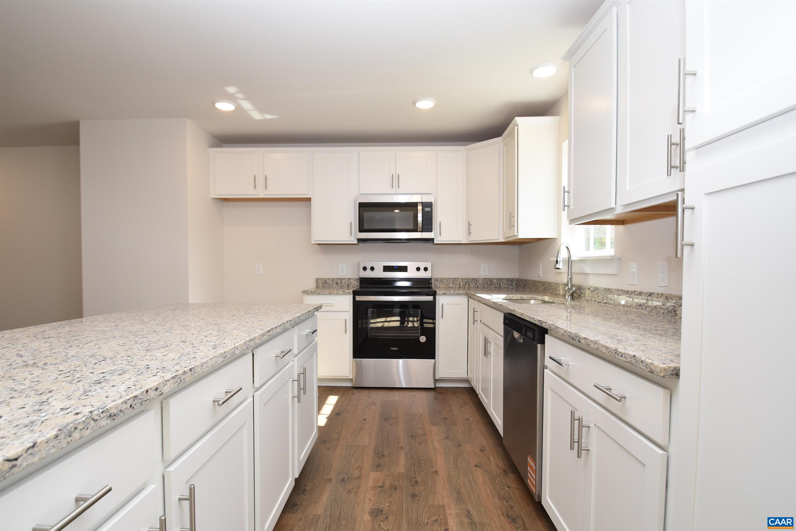 2600 Doctors Road Louisa, VA 23093 - Photo 8 of 25 a kitchen with granite countertop white cabinets and stainless steel appliances