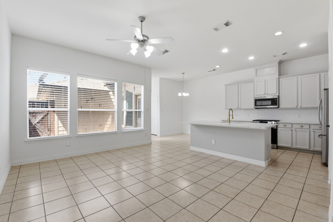 16023 Powder Springs Lane Houston, TX 77070 - Photo 48 of 48 Look at this open floor plan! What a perfect space to entertain! Living room, kitchen and breakfast room all open! Fresh nuetral paint, tile floors, faux white wood blinds, updated lighting!