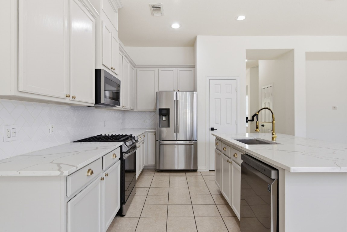 16023 Powder Springs Lane Houston, TX 77070 - Photo 17 of 48 Stainless steel dishwasher, updated gas stove/oven. Stainless steel microwave! What great lighting too!