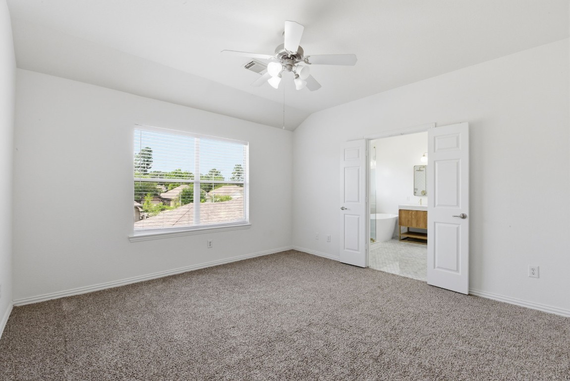 16023 Powder Springs Lane Houston, TX 77070 - Photo 31 of 48 Last look at primary bedroom with a peek into the primary bath.