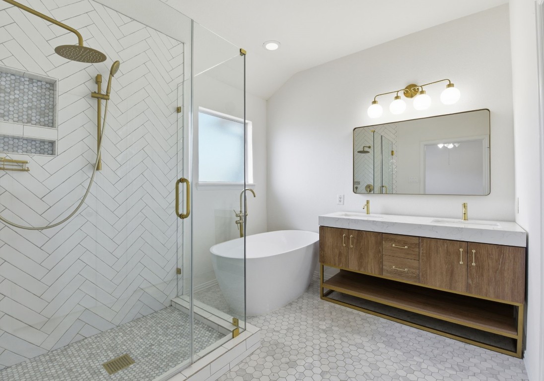 16023 Powder Springs Lane Houston, TX 77070 - Photo 32 of 48 This updated primary bath is breathtaking! Notice the updated floors, updated glass enclosed shower, updated vanity, mirror and lighting, along with the updated stand alone soaking tub!