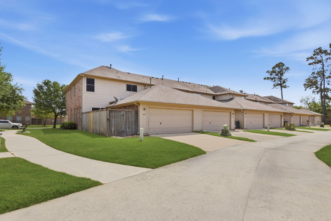 16023 Powder Springs Lane Houston, TX 77070 - Photo 46 of 48 A look from down the back street area. Lots of walkable green space right around the townhome.