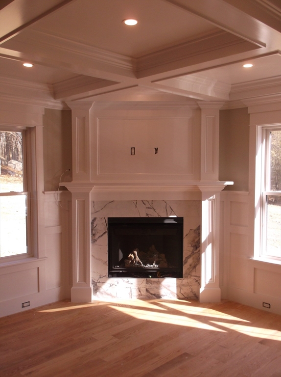Lot 8 Pond View Holliston, MA 01746 - Photo 15 of 30 a view of an empty room with wooden floor and a fireplace