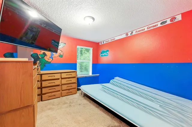 a view of a room with furniture and a flat screen tv