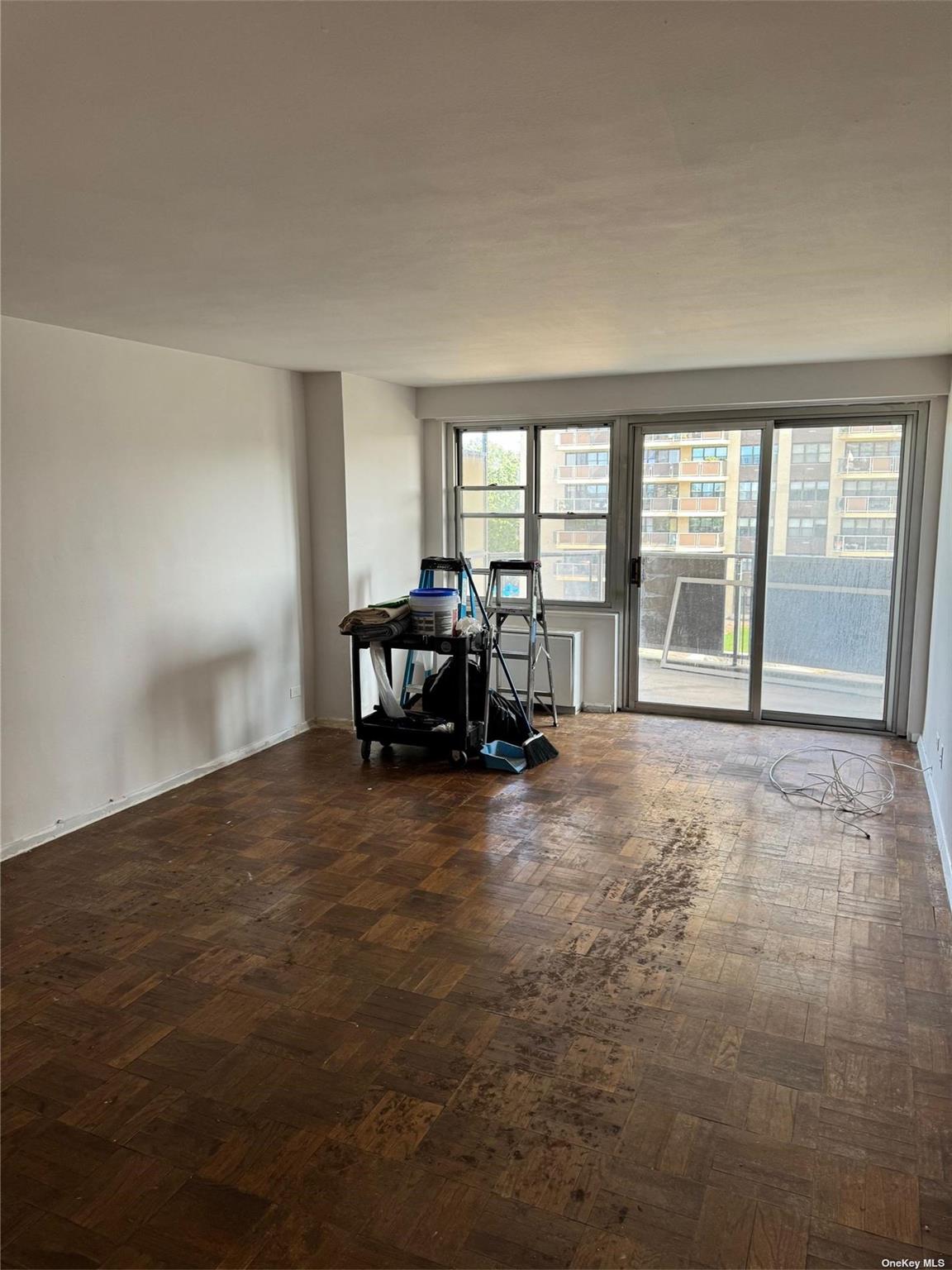 17-85 215th Street, Unit 4J Queens, NY 11360 - Photo 7 of 19 Freshly Painted Living room leading to Terrace with waterviews