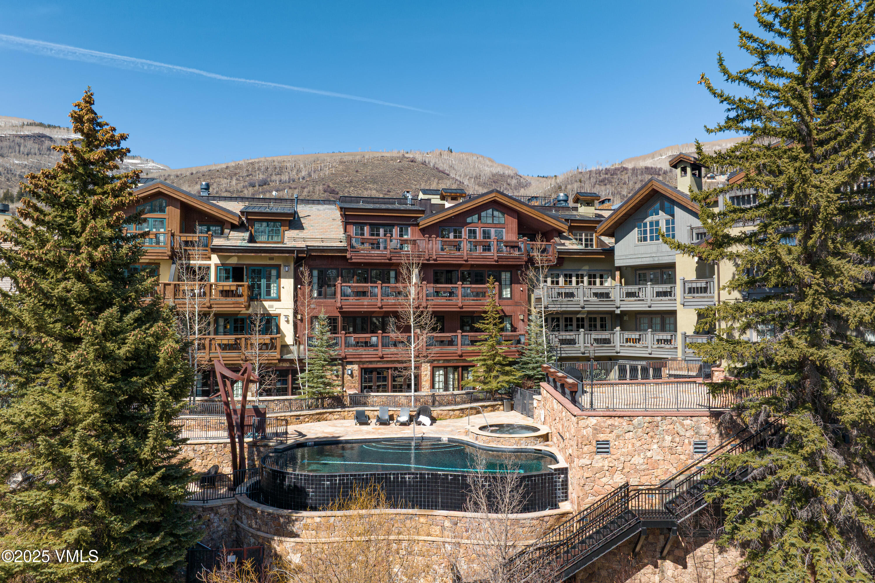 1 Willow Bridge Road, Unit 42 Vail, CO 81657 - Photo 64 of 72 a front view of a residential apartment building with a yard