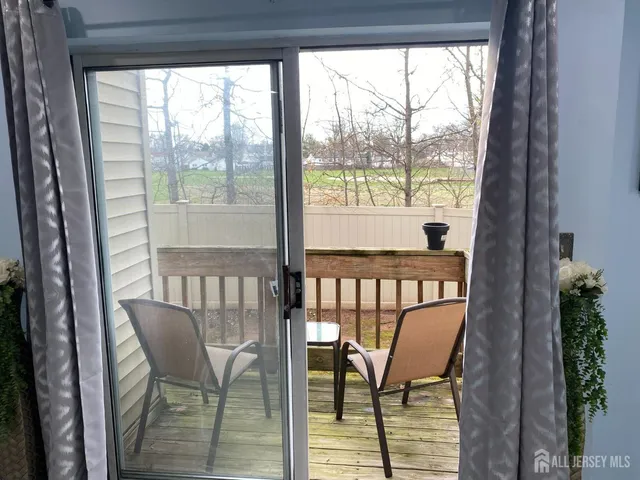 a view of a chair and table in the balcony
