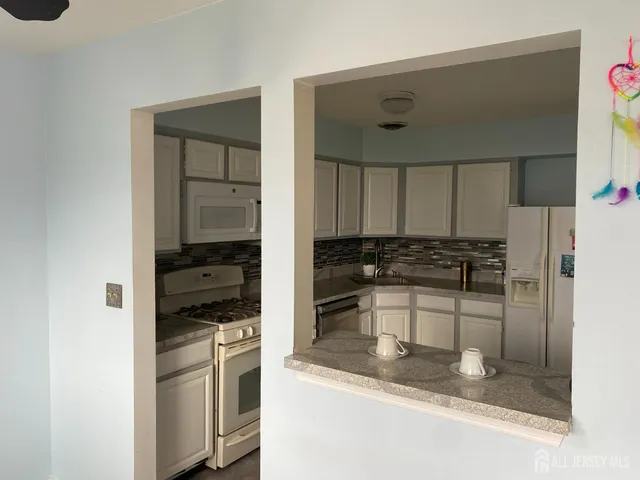 a kitchen with a refrigerator sink and stove