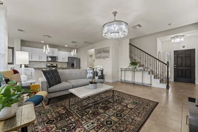 a living room with lots of furniture and a table