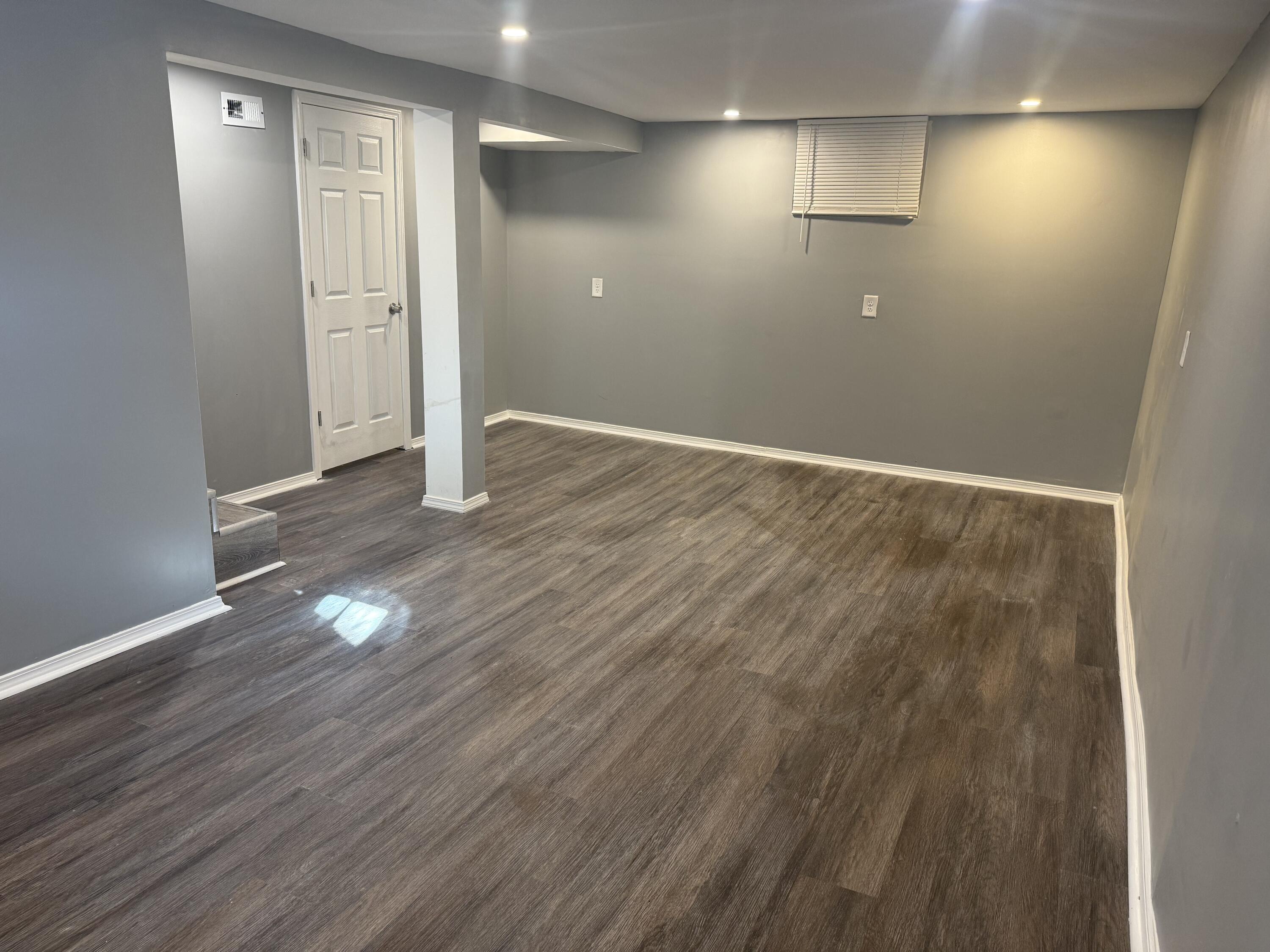 634 Kentucky Street Gary, IN 46402 - Photo 16 of 18 an empty room with wooden floor and windows