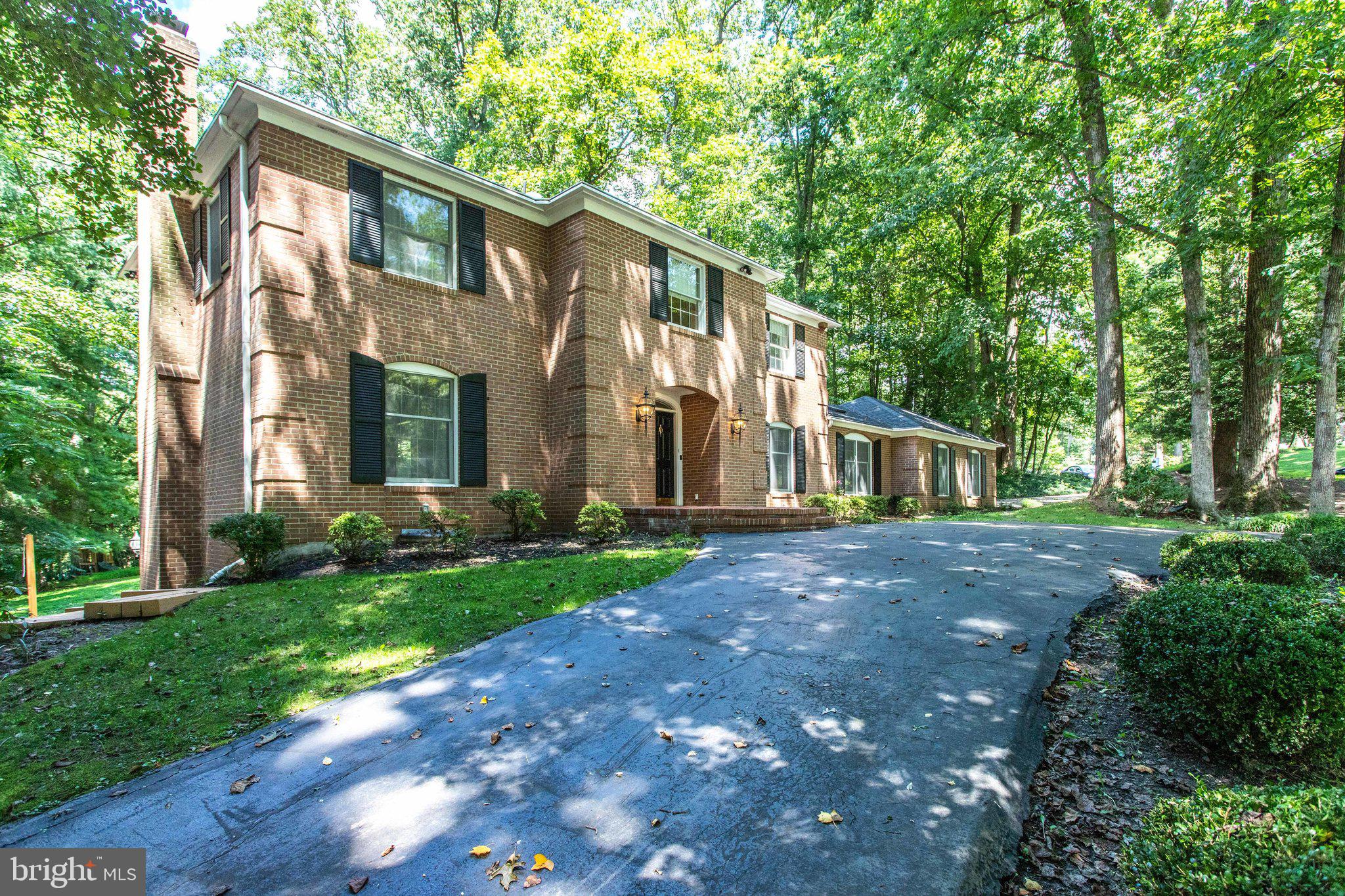 8500 Brook Road McLean, VA 22102 - Photo 2 of 44 a front view of a house with a yard and trees