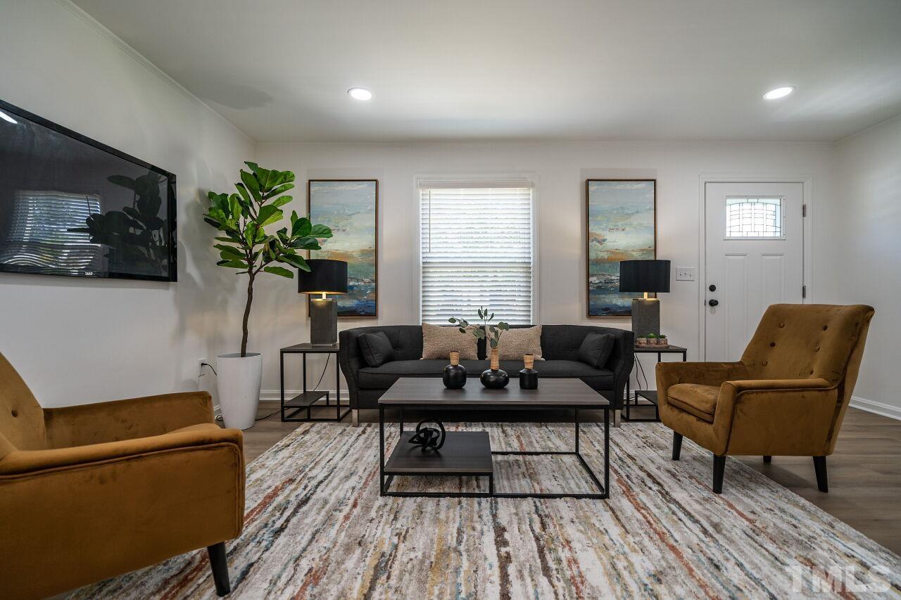2719 Layden Street Raleigh, NC 27603 - Photo 5 of 31 a living room with furniture and a flat screen tv