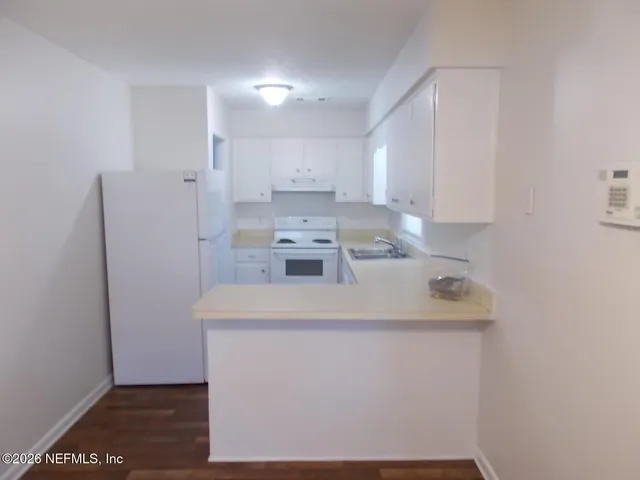 a kitchen with a sink a stove and refrigerator