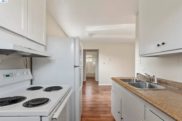 a kitchen with a sink stove and cabinets