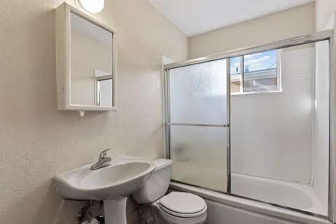 a bathroom with a sink toilet and shower