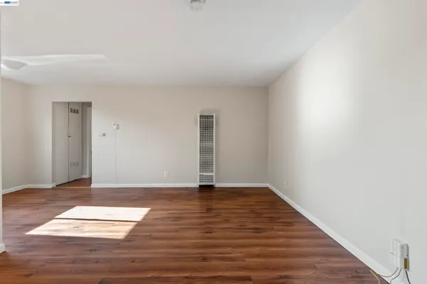 a view of an empty room and wooden floor