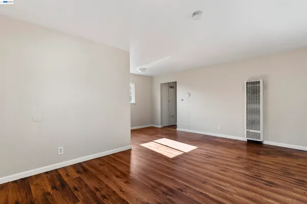 an empty room with wooden floor