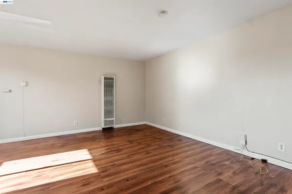 a view of an empty room and wooden floor