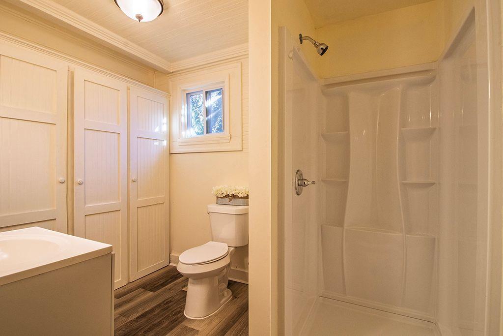 65 West Calhoun Street Wadley, GA 30477 - Photo 11 of 25 a bathroom with a toilet a sink and shower