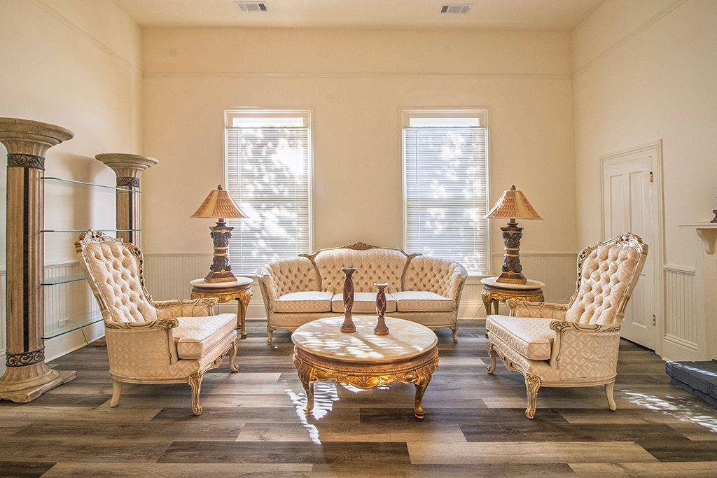65 West Calhoun Street Wadley, GA 30477 - Photo 4 of 25 a living room with fireplace a table and chairs