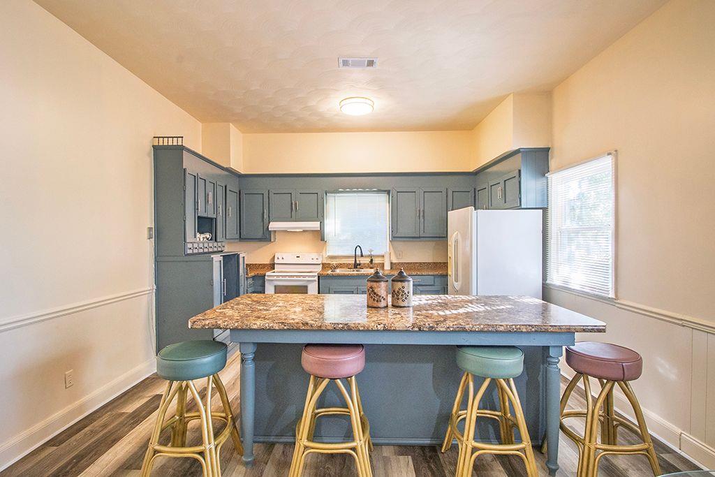 65 West Calhoun Street Wadley, GA 30477 - Photo 8 of 25 a view of a dining room with furniture and wooden floor