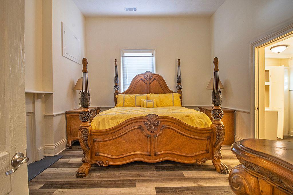 65 West Calhoun Street Wadley, GA 30477 - Photo 10 of 25 a bedroom with a bed and wooden floor